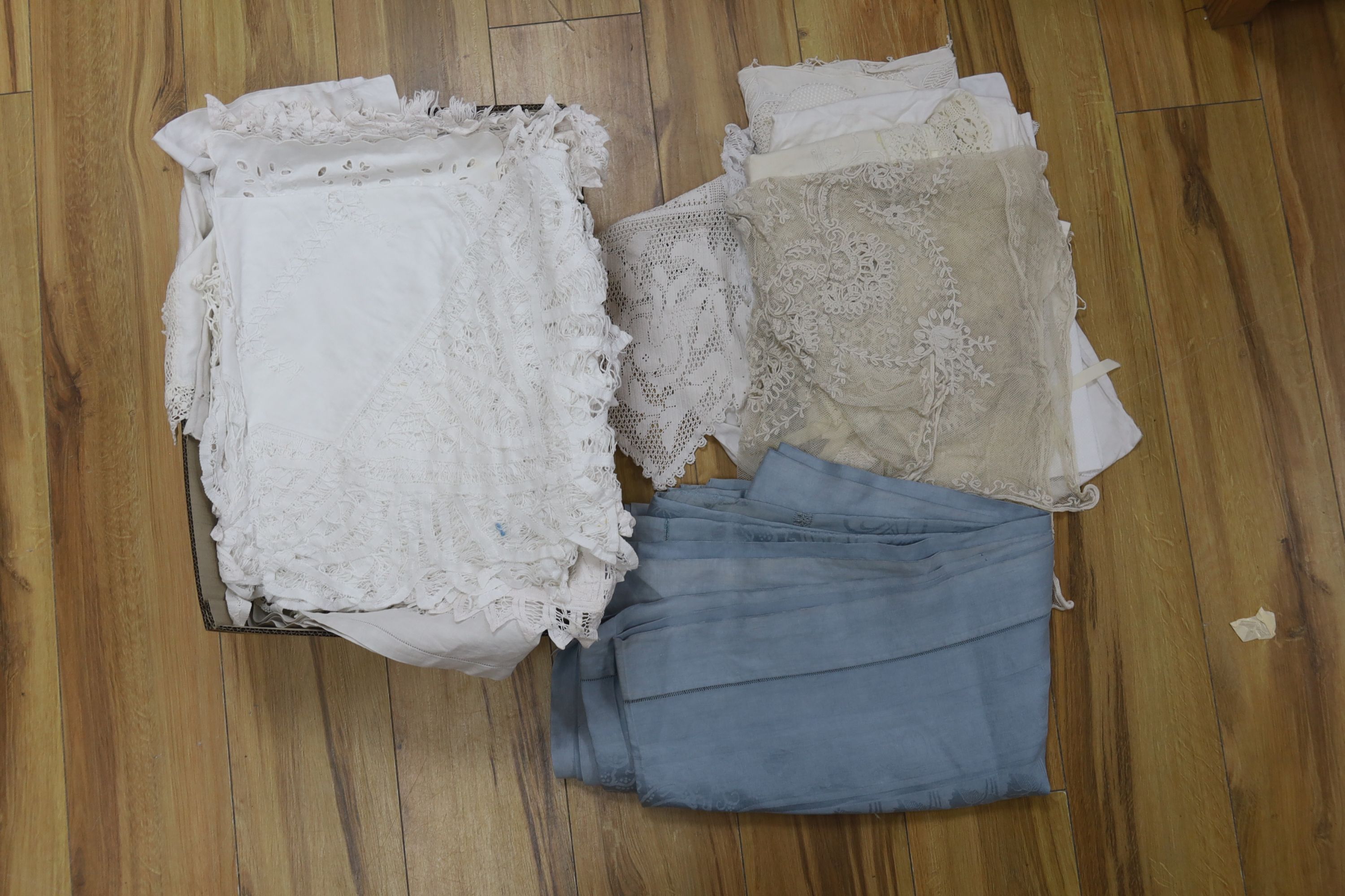 A large collection of table linen including drawn thread work, tape lace, cutwork and crochet cloths, mats. etc